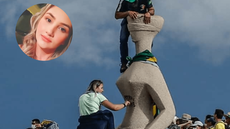 Momento em que Débora escreve “Perdeu, mané” na estátua “A Justiça” durante os Atos de 8 de janeiro de 2023 - Imagem: Reprodução / Gabriela Biló/Folhapress