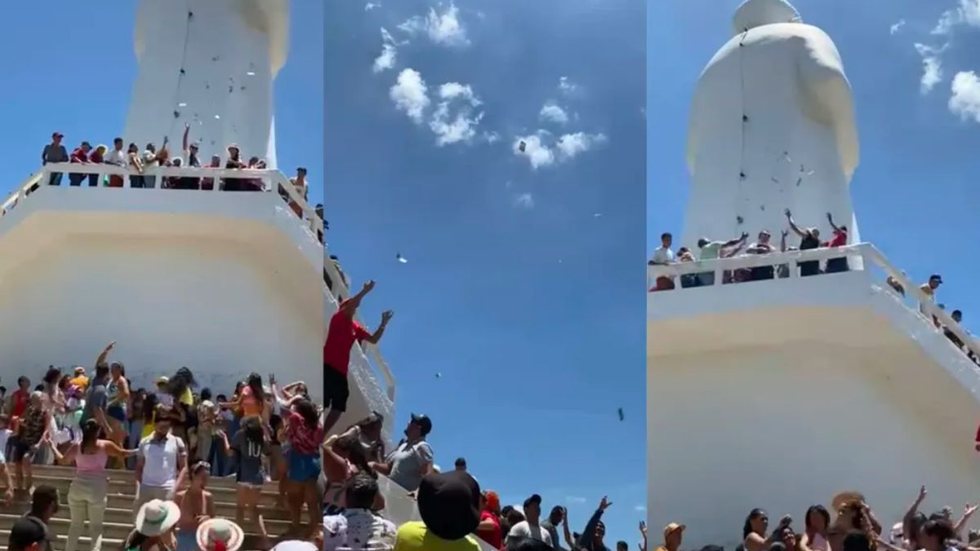 Turista faz 'chuva de dinheiro' no alto de estátua; entenda o porquê - Imagem: reprodução TV Globo