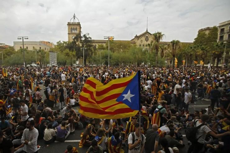 Manifestante exibe bandeira separatista da Catalunha durante manifestação desta terça-feira (3) em Barcelona (Foto: AP Photo/Francisco Seco)
