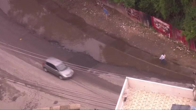 Estrada que corta as comunidades da Muzema e de Rio das Pedras ainda tinha bolsões d'água — Foto: Reprodução/TV Globo