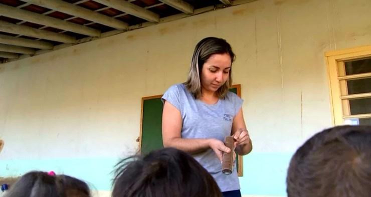 A auxiliar de serviços gerais Viviane Lopes durante distribuição de lanche aos alunos: 