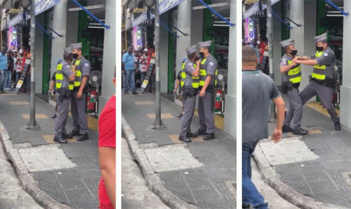 PM aponta a arma para o rosto do colega da corporação, que reage. Caso ocorreu no Centro de São Paulo e foi gravado por pedestres; imagens circulam nas redes sociais — Foto: Reprodução/ Redes sociais