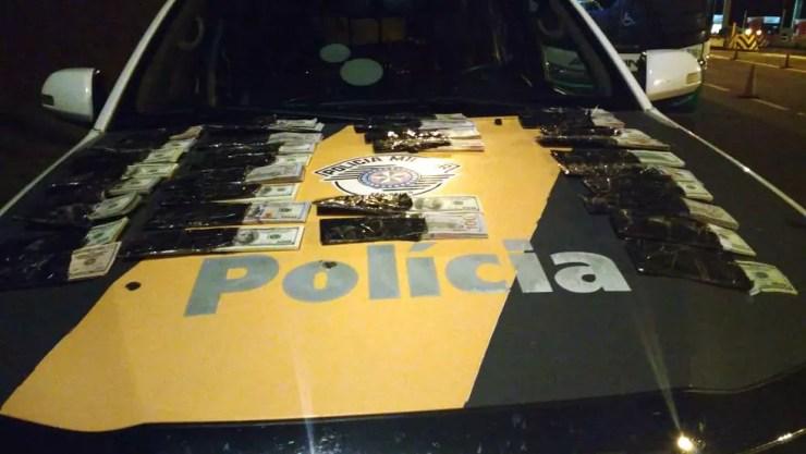 Cerca de 110 mil dólares estavam em fundo falso de mala de passageiro (Foto: Polícia Rodoviária/Divulgação )