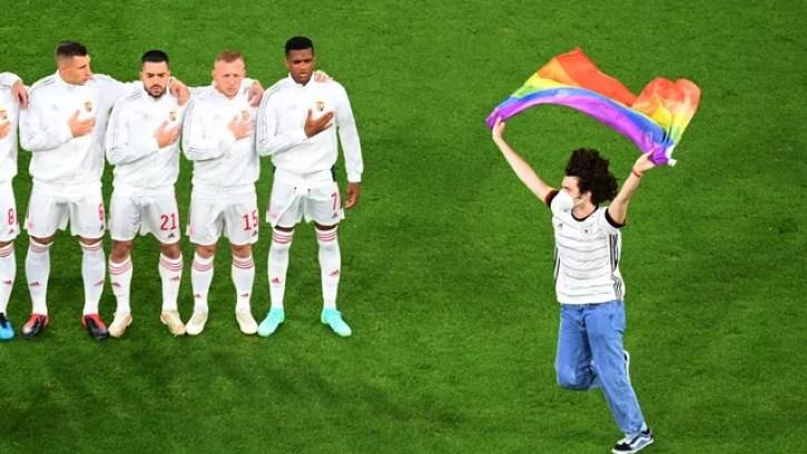 Ativista LGBTQ+ invade o gramado e abre bandeira nas cores do arco-íris