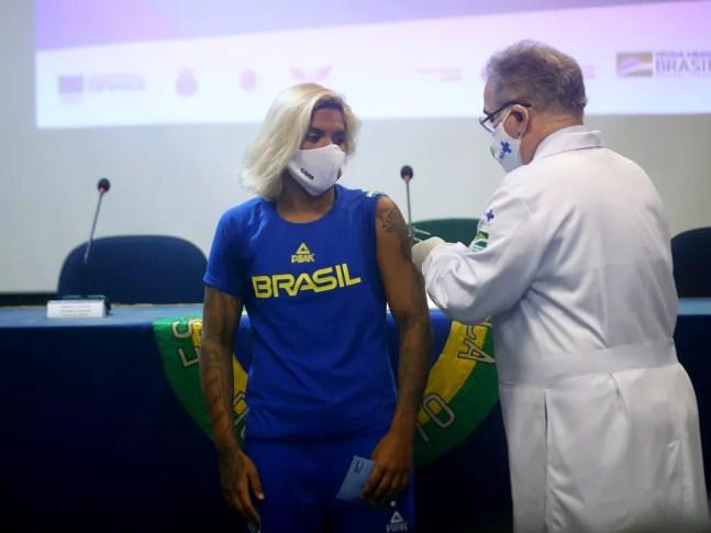 Ana Marcela Cunha é vacinada pelo ministro Marcelo Queiroga — Foto: REUTERS/Pilar Olivares