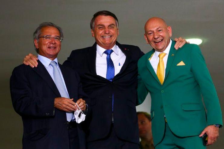 O empresário Luciano Hang, o presidente Jair Bolsonaro e o ministro da Economia, Paulo Guedes, durante o lançamento do programa Voo Simples, no Palácio do Planalto.