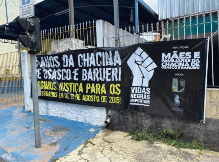Familiares das vítimas da chacina de 2015 protestam com cartazes em frente ao Fórum de Osasco — Foto: Filippo Mancuso/TV Globo