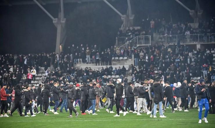 Torcida invade o gramado após confusão com torcedores do Lyon na arquibancada em jogo com Paris FC na Copa da França — Foto: Bertrand Guay/AFP